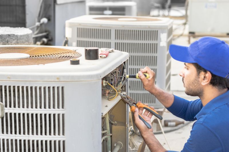 Technician Repairing Air Conditioner